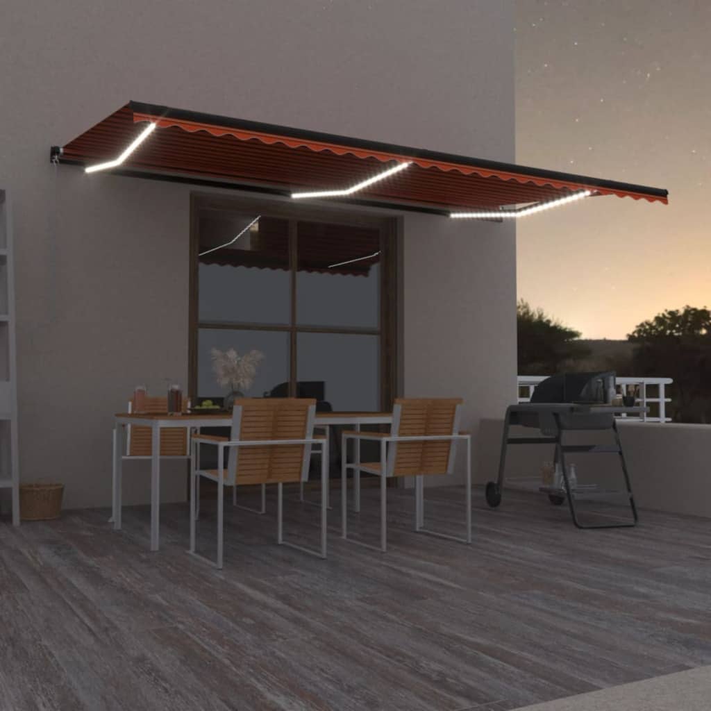 Manuaalisesti sisäänvedettävä markiisi LED-valoilla 600x300 cm oranssi ja ruskea